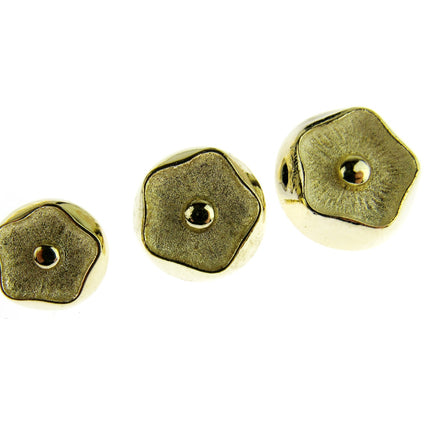 Gold Poppy head style shank buttons on a white background