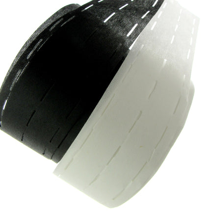 A roll of slotted waist banding interfacing in black and white colours.