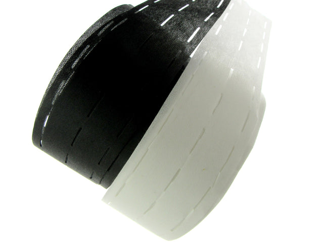 A roll of slotted waist banding interfacing in black and white colours.