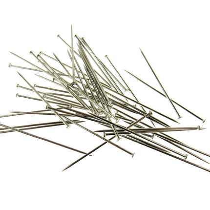A selection of long straight steel pins on a white background