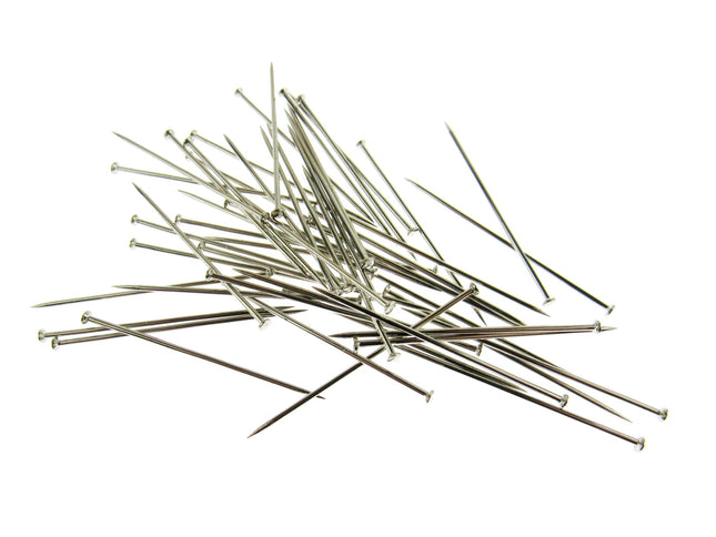 A selection of long straight steel pins on a white background
