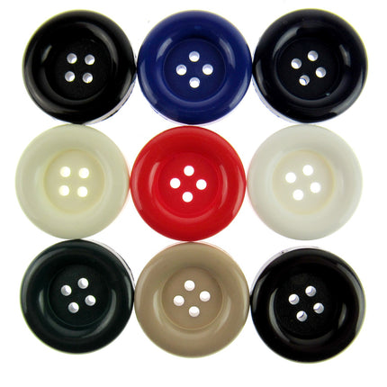A set of round large ladies' coat buttons in various colors including black, blue, red, white, beige, green, and black again, arranged neatly in a grid pattern.