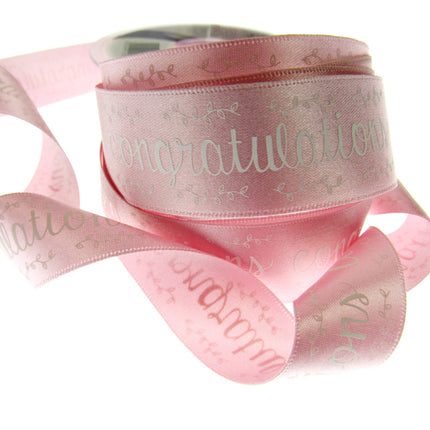 Pink satin congratulations ribbon on a white background