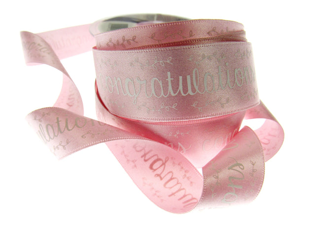 Pink satin congratulations ribbon on a white background