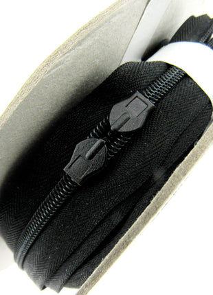 Six meters of continuous invisible zip chain on a roll with 12 sliders available in black, ivory, white and cream