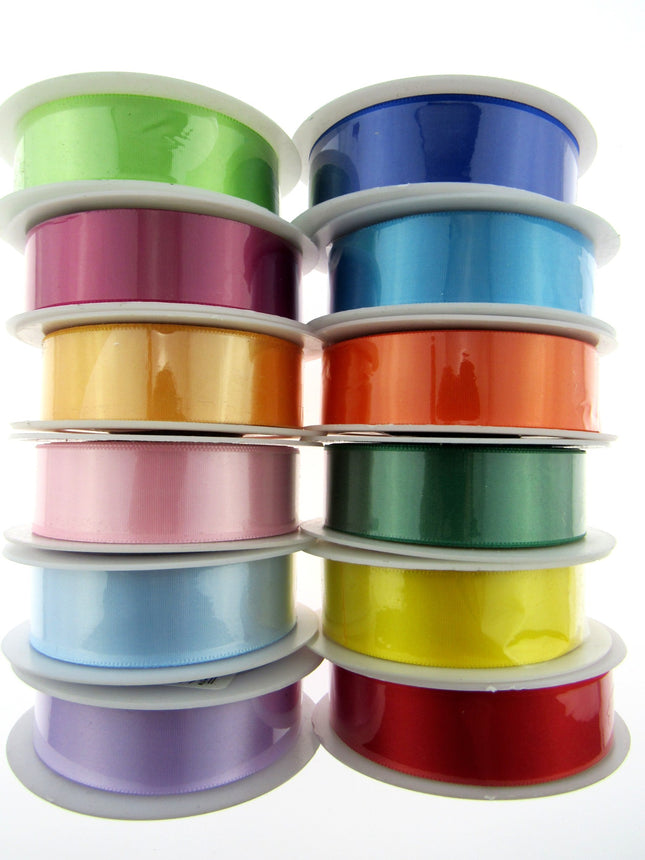 A collection of satin ribbons with woven edges, displayed in various colors.