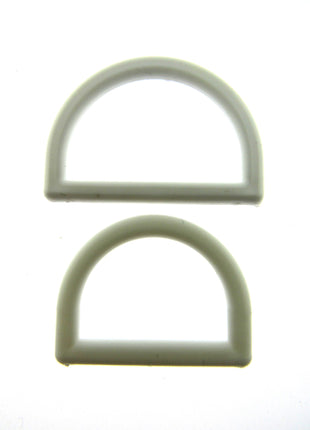 White plastic D rings on a white background