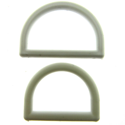 White plastic D rings on a white background