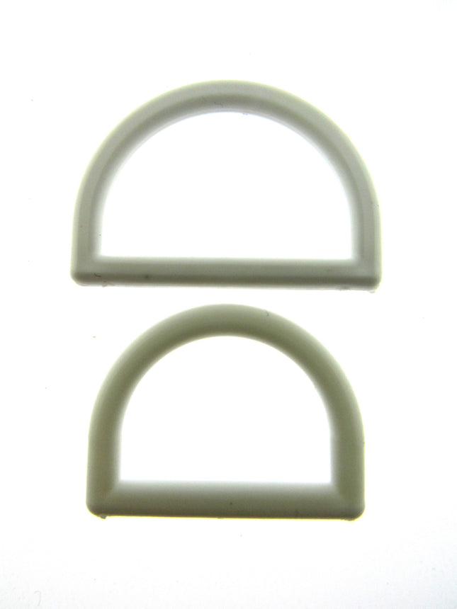 White plastic D rings on a white background
