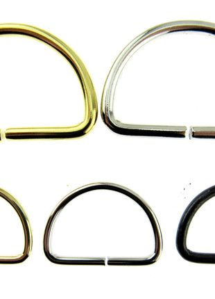 Silver and gold D rings side by side with smaller sizes in black silver and gold