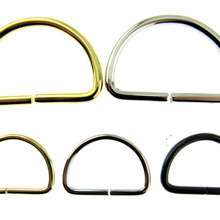 Silver and gold D rings side by side with smaller sizes in black silver and gold