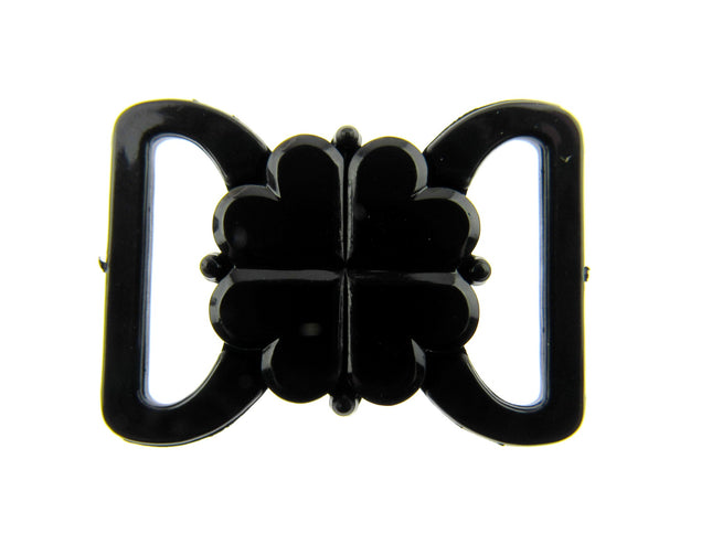 Black plastic snap bikini clip with a clover leaf design for swimwear straps.