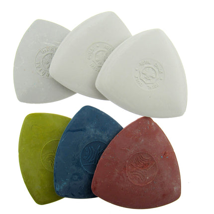 A collection of tailor's chalk in various colors including white, green, blue, and red, with triangular shapes and a textured surface.