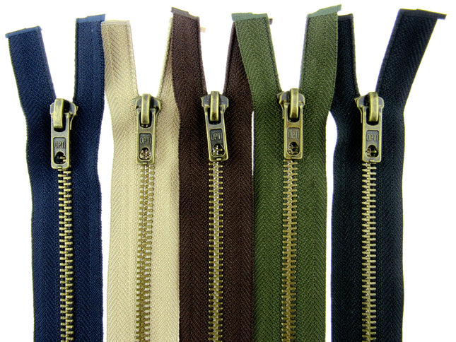 A selection of antique brass metal open end zips in various colors including black, brown, beige, navy, and green, displayed side by side.