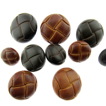 A selection of tab and brown leather look buttons on a white background