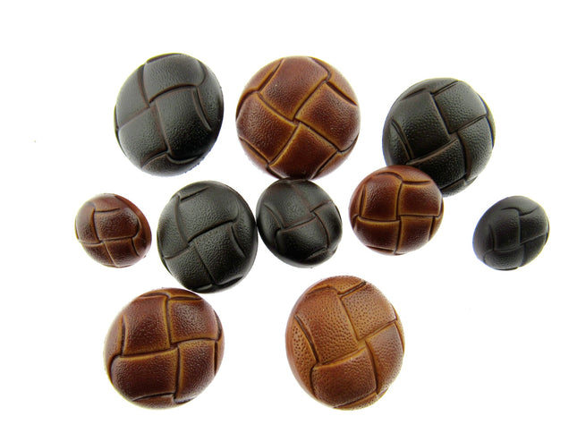A selection of tab and brown leather look buttons on a white background