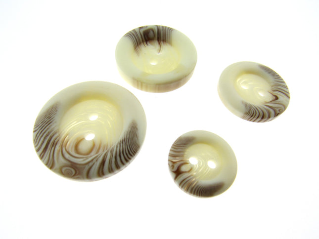 A set of four round 2-hole sew-through buttons with a brown fleck design.