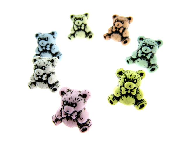 Etched teddy bear buttons in pastel colours on a white background