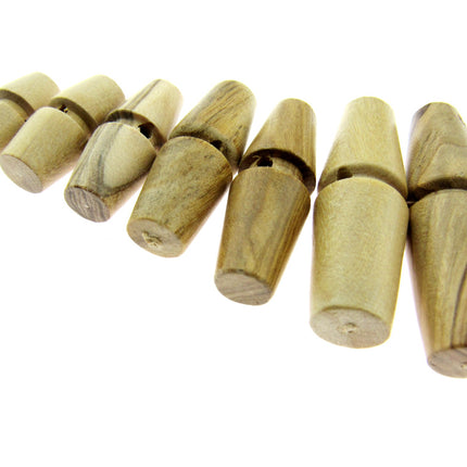 A collection of wooden toggles made from olive wood, displayed in a row with different sizes.