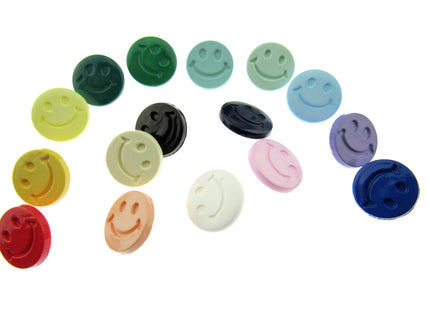 Smiley face buttons in an array of colours on a white background