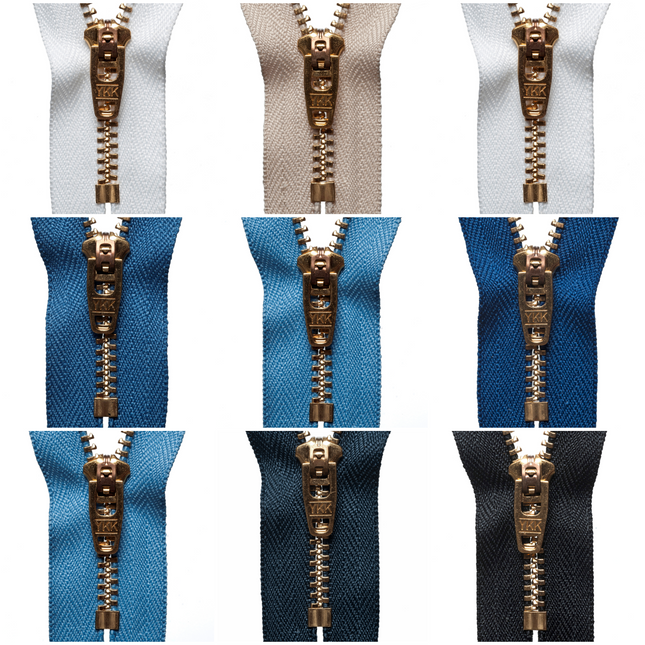 A collection of brass jean zippers in various colors displayed side by side.